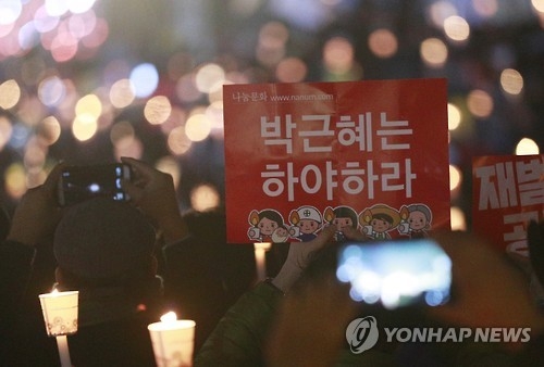 參加集會的人群手持“樸槿惠下臺”的標語。(韓聯社)