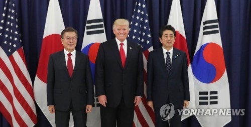 當地時間7月6日下午,在德國漢堡美國總領事館,南韓總統文在寅(左)、美國總統特朗普(中)和日本首相安倍晉三在共進晚餐前合影留念。(韓聯社)