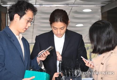 3月21日,鄭俊英(中)站在首爾中央地方法院門口。(韓聯社)