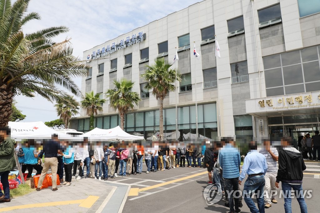 6月19日,在濟州出入境事務所,葉門難民排隊領取應急物資。(韓聯社/讀者提供)