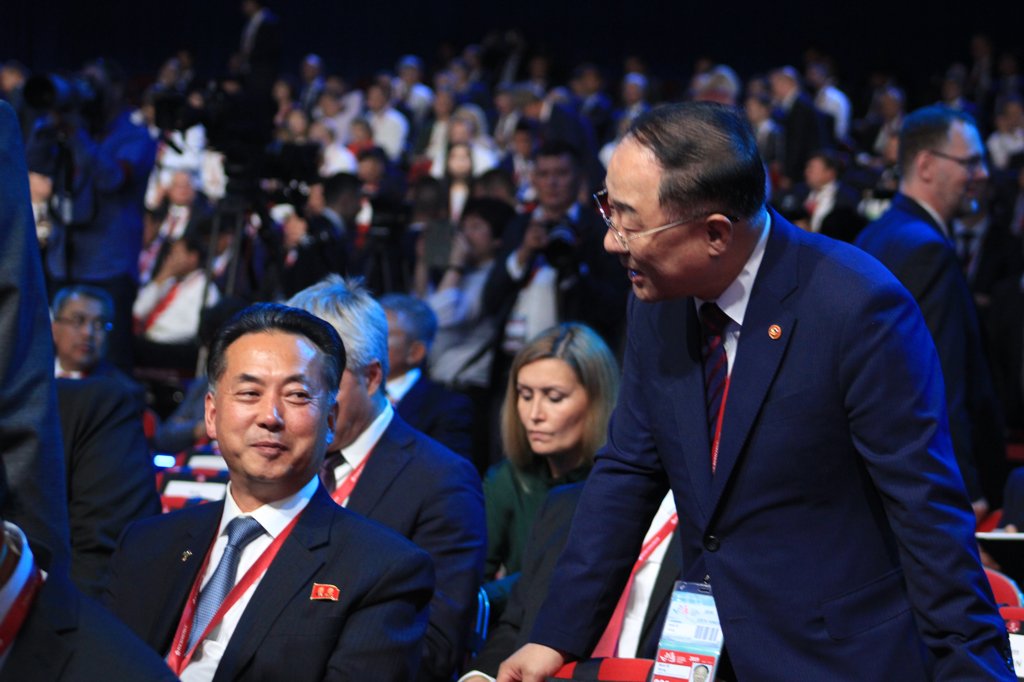 南韓副總理兼企劃財政部長洪楠基(右)與朝鮮內閣副總理李龍男互致問候。韓聯社