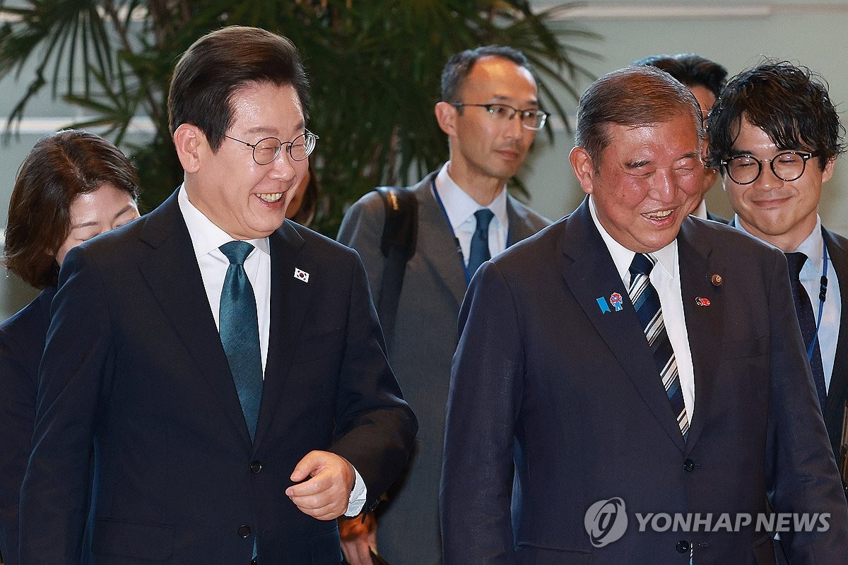 8月23日,在日本首相官邸,南韓總統李在明(左)在日本首相石破茂的陪同下前往會談地點。 韓聯社